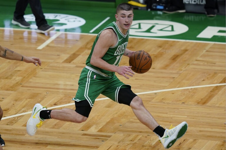 Boston Celtics guard Payton Pritchard handles the ball during the first half of an NBA basketball game against the Orlando Magic, Friday, Jan. 15, 2021, in Boston. (AP Photo/Elise Amendola)